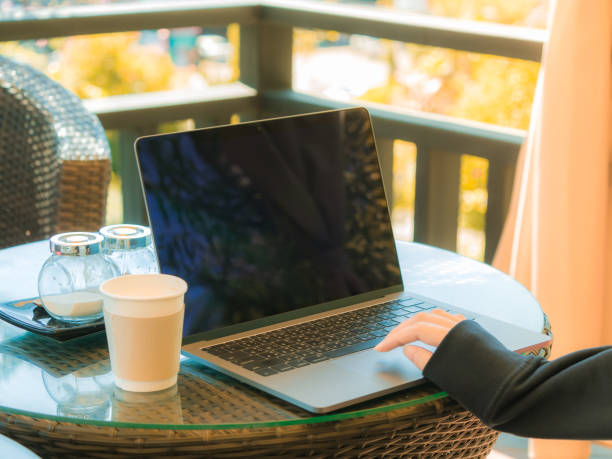 istock business and coffee break concept from freelancer working with computer laptop and drink coffee at outdoor coffee shop in the morning time with soft focus background 952360006