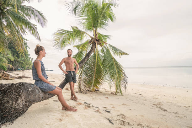istock Young couple enjoying vacations on tropical beach, palm tree 952361278