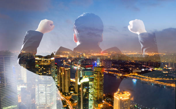 istock Multiple exposure of businessman clenching fist 952361406