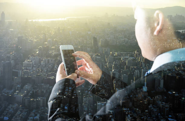 istock Multiple exposure of businessman hand using smart phone 952362220