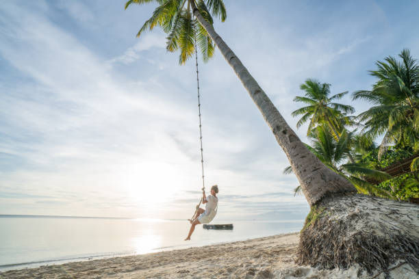 Young woman playing on beach, swing rope on palm tree Young woman playing on beach, swing rope on palm tree. People travel exotic concept
Shot in the Philippines on tropical Island vacations siquijor stock pictures, royalty-free photos & images