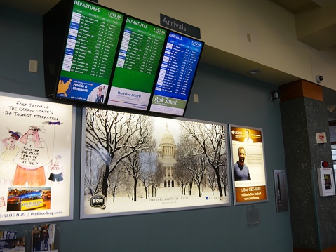 WARWICK, RHODE ISLAND—SEPTEMBER 2017: Digital flight information board and photos of the island displayed inside the T. F. Green Airport in Warwick, Kent County, Rhode Island.