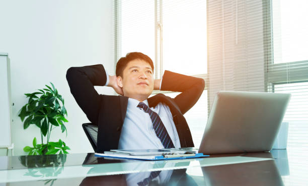istock Businessman leaning back in the office chair 952372992