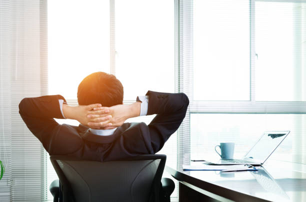 istock Businessman leaning back in the office chair 952375418