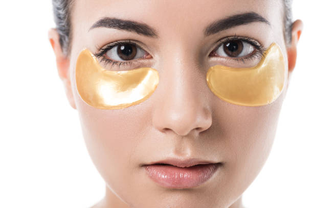 istock beautiful girl with moisturizing under eyes patches looking at camera isolated on white 952384486