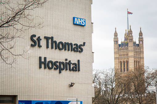 Exterior and signage of St Thomas Hospital, a large NHS teaching hospital next to Westminster Bridge in central London