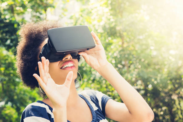 istock Afro woman enjoying watching  3D simulation video from virtual reality (VR) headset 952389150