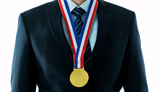 Gold medal hanging around a man neck.