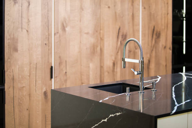 istock Kitchen faucet, modern kitchen in loft style, black marble table, wooden luxury kitchen 952394356