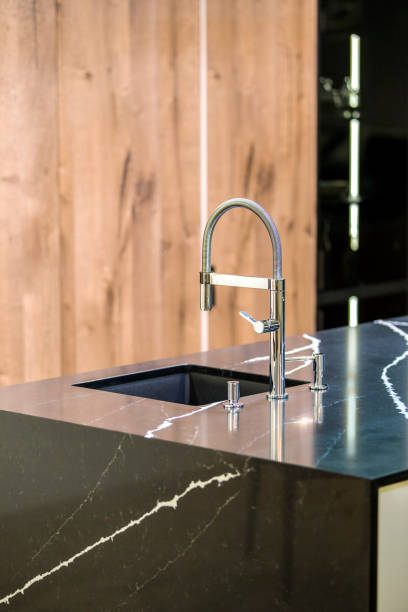 istock Kitchen faucet, modern kitchen in loft style, black marble table, wooden luxury kitchen 952394396