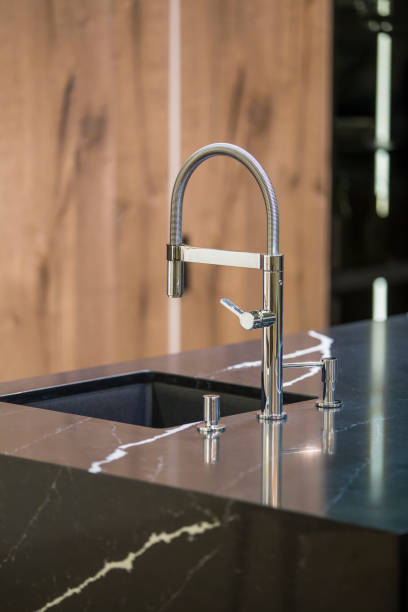 istock Kitchen faucet, modern kitchen in loft style, black marble table, wooden luxury kitchen 952394418