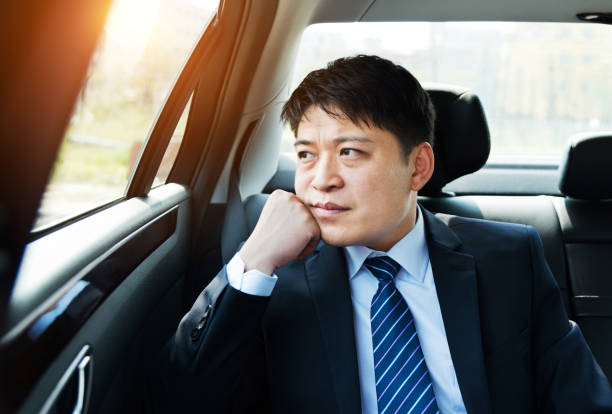 istock Businessman at back seat of car 952397520