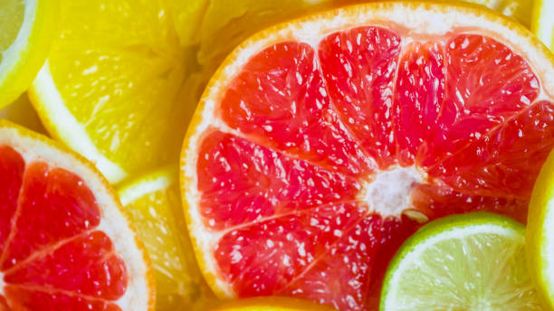 istock Macro image of grapfruit, otnage and lime juicy slices 952397542