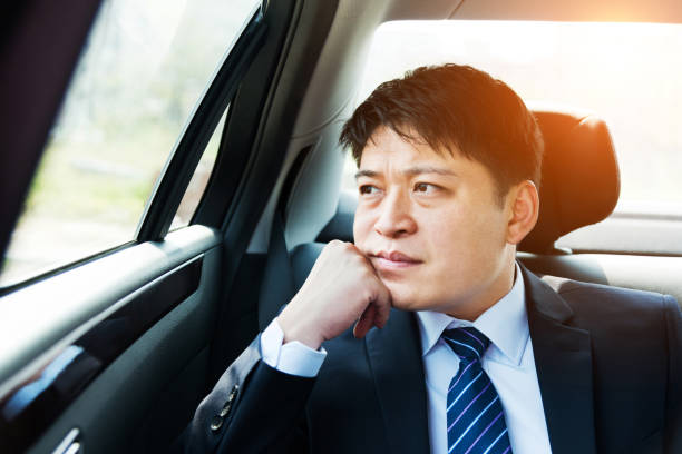 istock Businessman at back seat of car 952397590