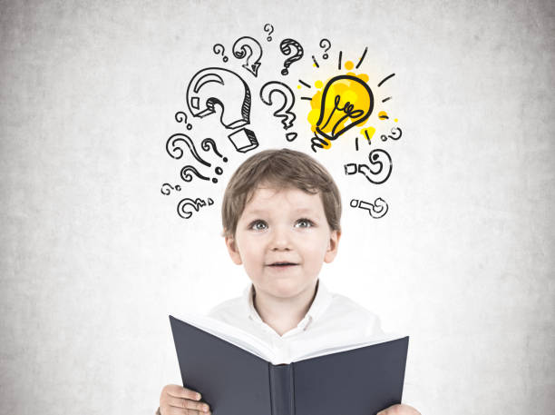 istock Cute little boy with a book, questions and answer 952398914