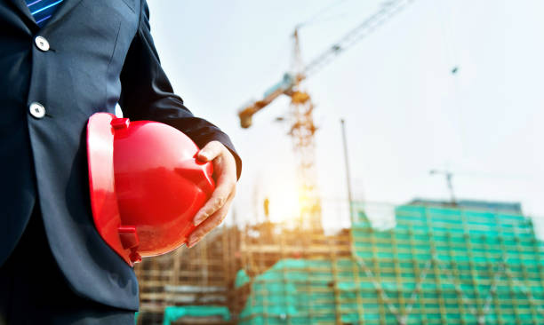 istock Businessman holding a hardhat under his arm 952399214