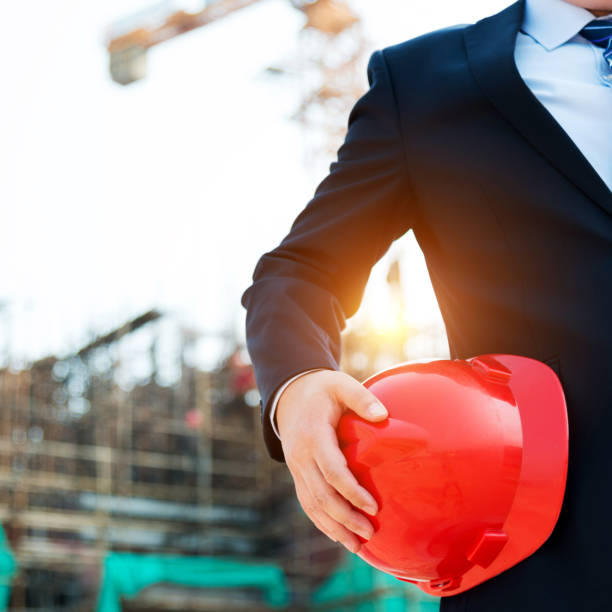 istock Businessman holding a hardhat under his arm 952399228