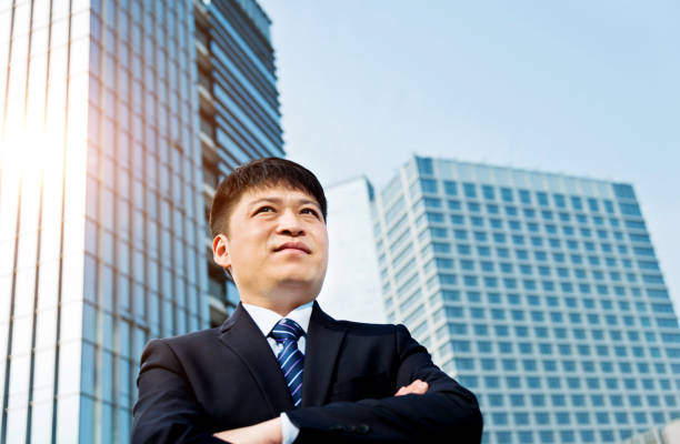 istock Businessman standing in front of office building 952402602