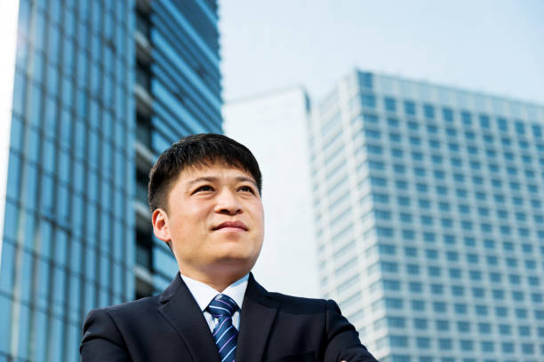 istock Businessman standing in front of office building 952402620