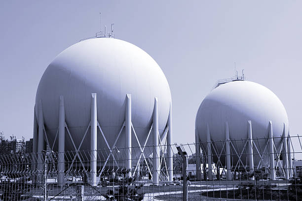istock Large white circular storage tanks at a natural gas facility 95240527