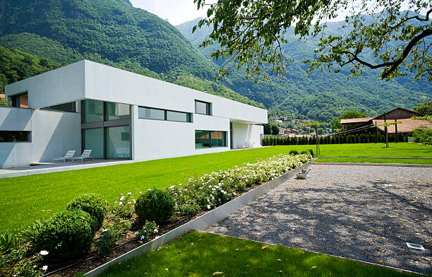 istock Modern white house with green hills and grass 95240599