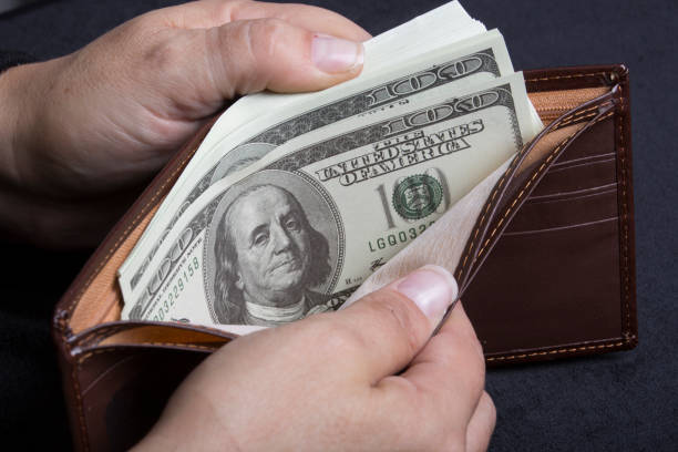 A man's wallet isolated on a white background. A textured shadow feathers into the background.