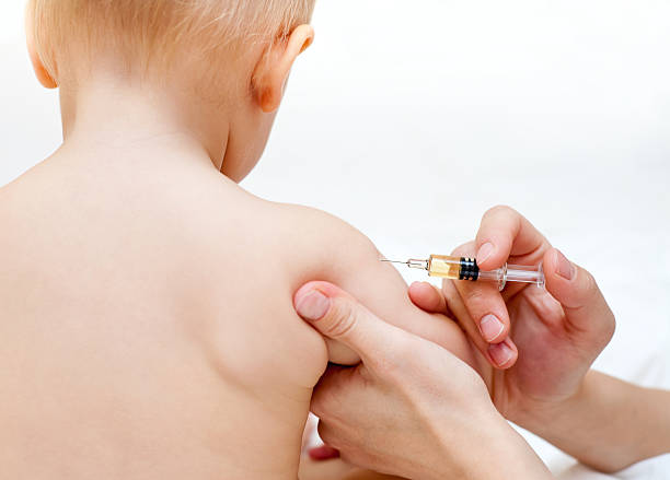 istock Young boy receiving an injection from the doctor 95240845
