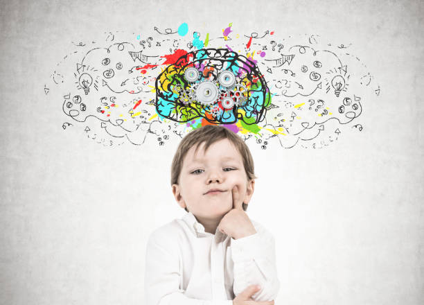 istock Thinking little boy, finger on cheek, cog brain 952408742