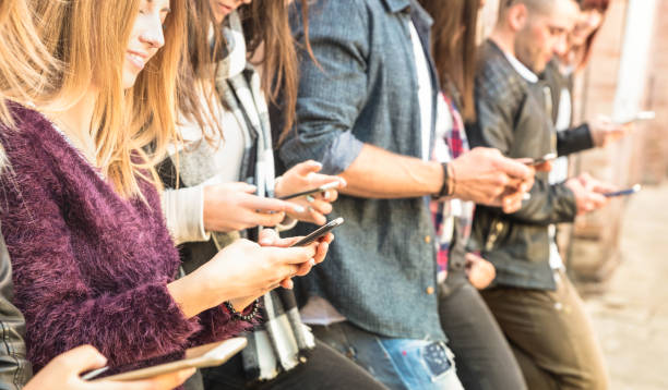 istock Group of multicultural friends using smartphone at university college backyard break - People hands addicted by mobile smart phone - Technology concept with always connected millennials - Filter image 952415044