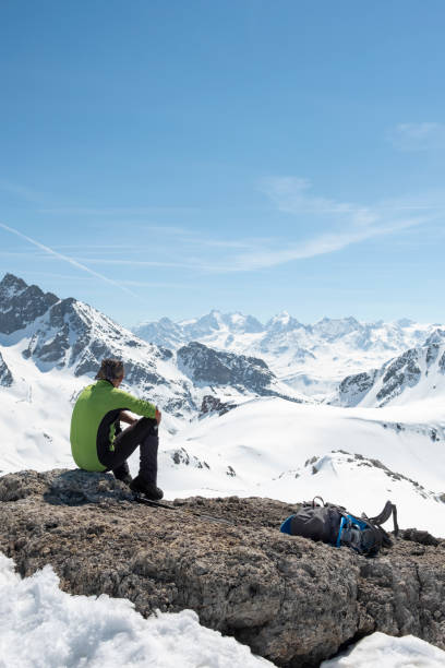 istock Alpinist taking a break on mountain peak 952415172