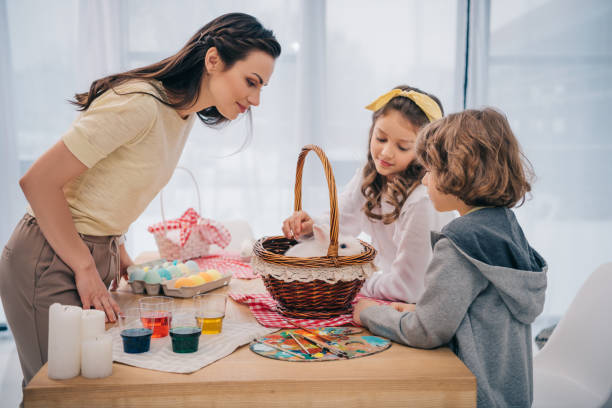 istock kids and mother playing with easter rabbit at home on table 952416224
