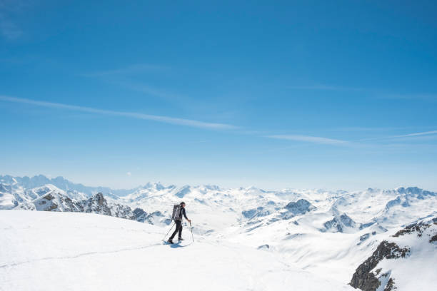 Mountaineer on a snow capped majestic valley Hiker snowshoeing on mountain graubunden canton stock pictures, royalty-free photos & images