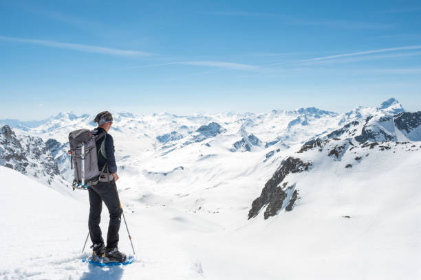 istock Alpinist walking on snow capped mountain valley 952420956