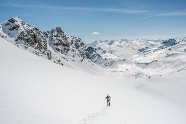 istock Mountaineer on a snow capped majestic valley 952421208