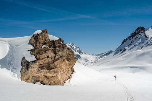 Hiker snowshoeing on mountain