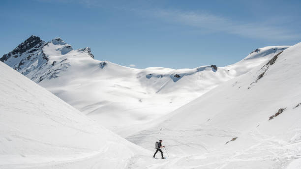 istock Mountaineer on a snow capped majestic valley 952421702