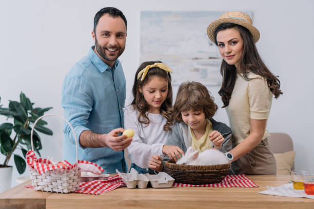 istock young family with colorful eggs and rabbit preparing for easter 952425790