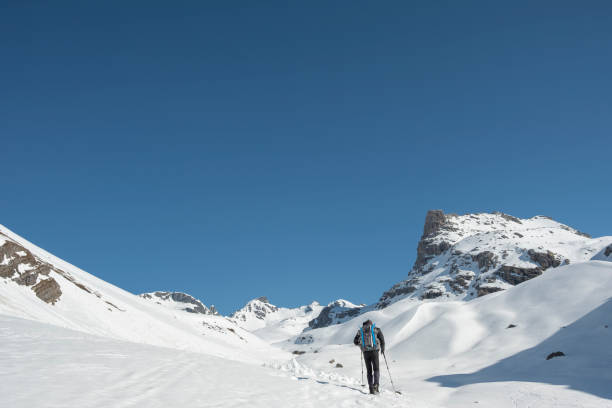 istock Hiker during ascent in the mountains with snowshoes 952436642