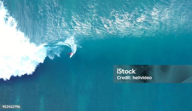 Top Down Unrecognizable Pro Surfer Riding A Stunning Blue Ocean Wave In The Sun Stock Photo - Download Image Now