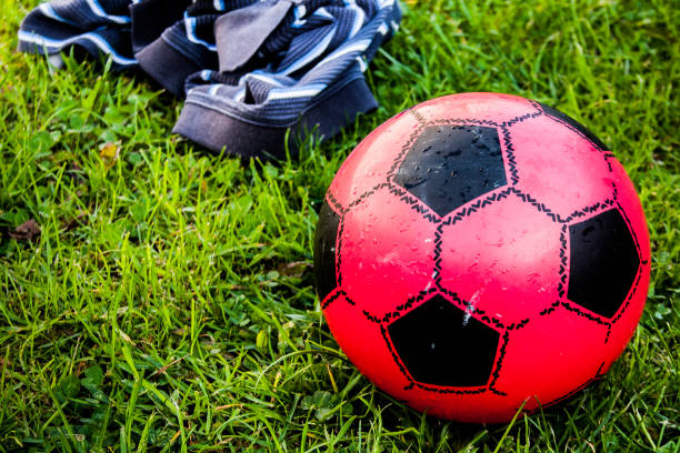 istock A child's small red football lying on green grass 952453482