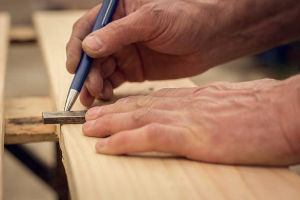 istock Handyman preparing wooden boards for cutting 952466972