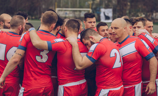 rugby-spieler während der auszeit kauern - rugby scrum sport effort stock-fotos und bilder