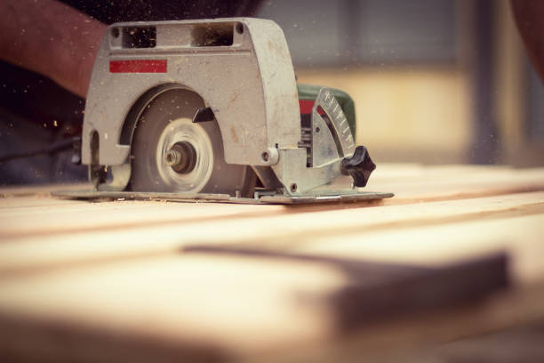 istock Carpenter cutting wood with circular saw 952468218
