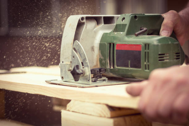 istock Carpenter cutting wood with circular saw 952470810