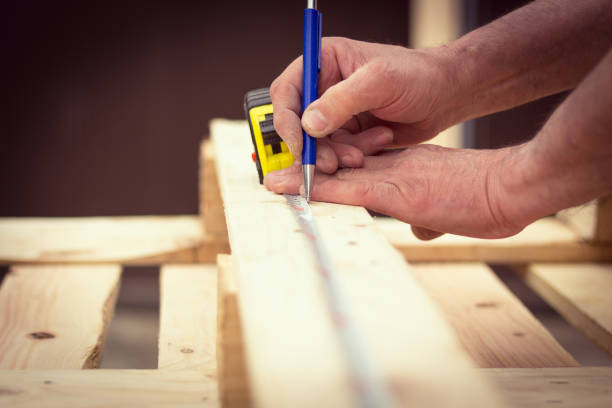 istock Handyman preparing wooden boards for cutting 952470904