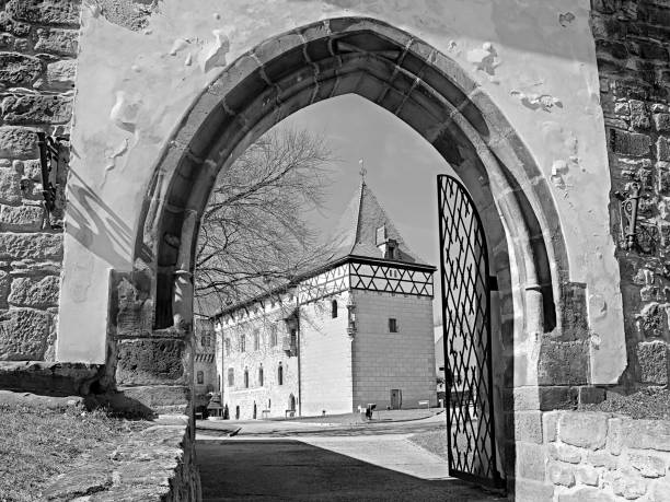 Budyne nad Ohri, Czech republic - April 07, 2018: entrance gate leading to Vodni hrad castle  at beginning spring with black and white stylization