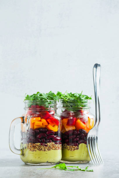 istock rainbow colored salad in jars on the table. with beans, fresh ve 952476338