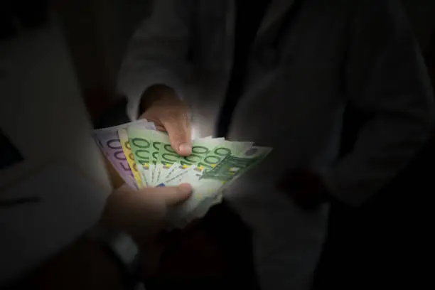Man giving bribe to a doctor