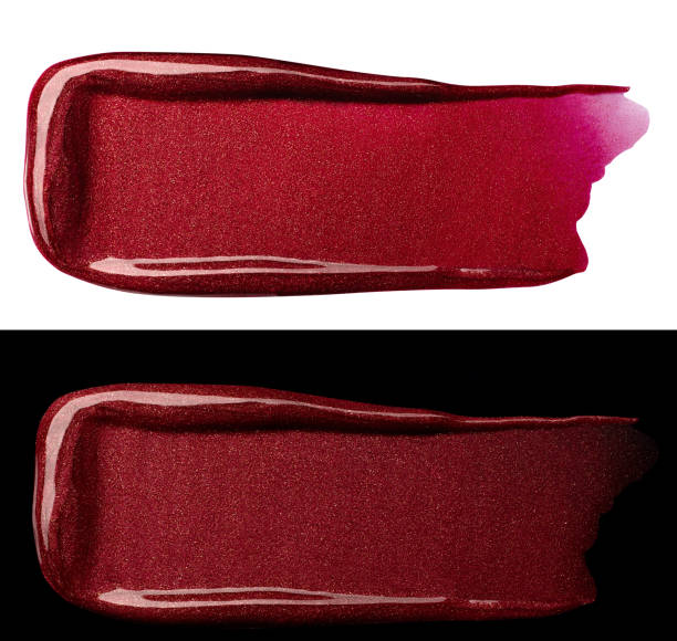 Two red shimmery lip gloss make-up smears isolated over white and black backgrounds