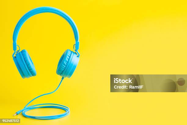 Bright Blue Headphones On Yellow Stock Photo - Download Image Now - Headphones, Colored Background, Music